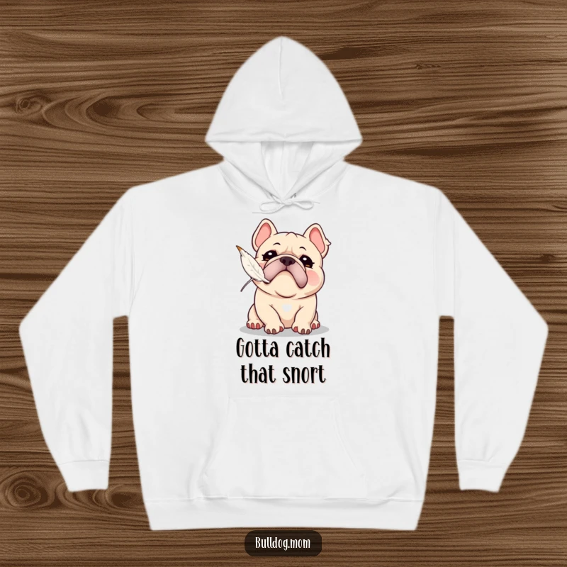 Funny Kawaii Bulldog hoodie with a playful snort, attempting to catch a floating feather, offering cozy comfort and humorous action.